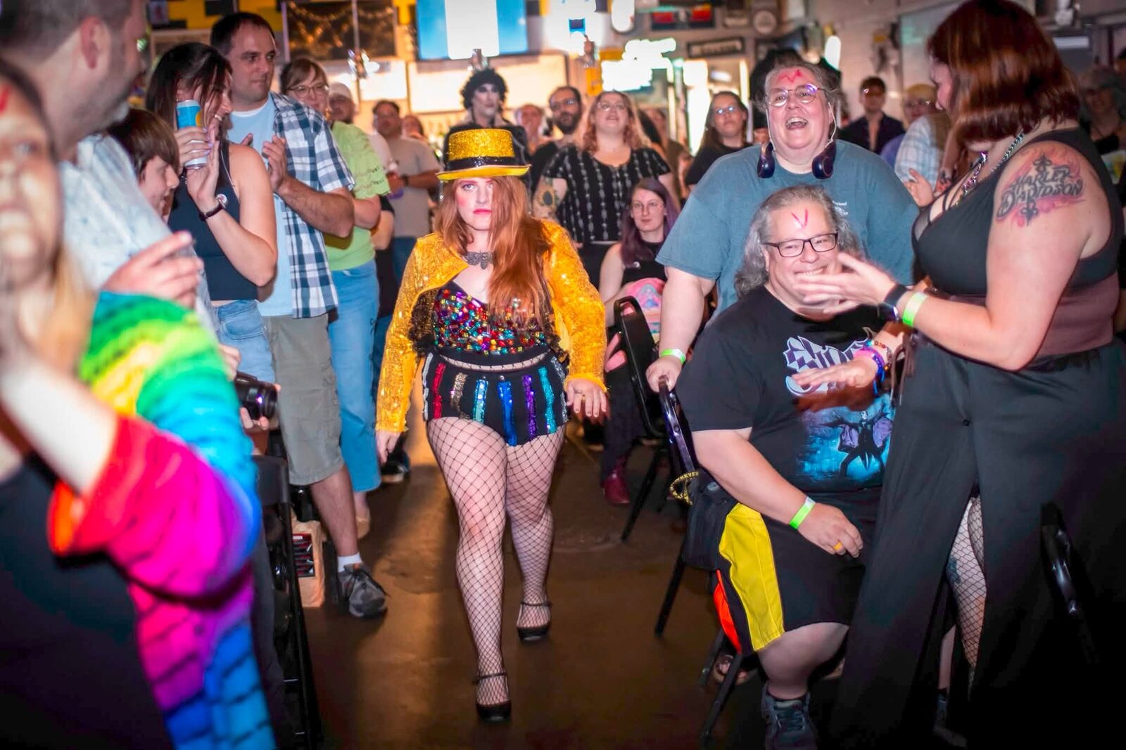 Columbia making her entrance through the crowd in a gold sequin jacket and top hat